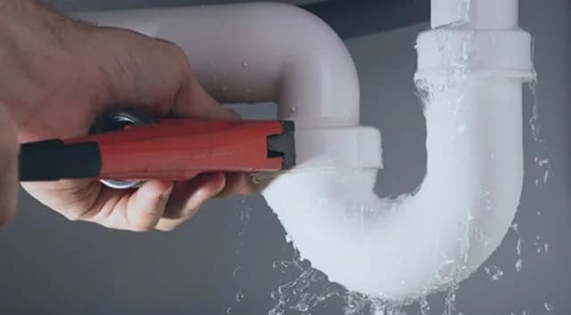 Technician detecting and repairing a hidden water leak